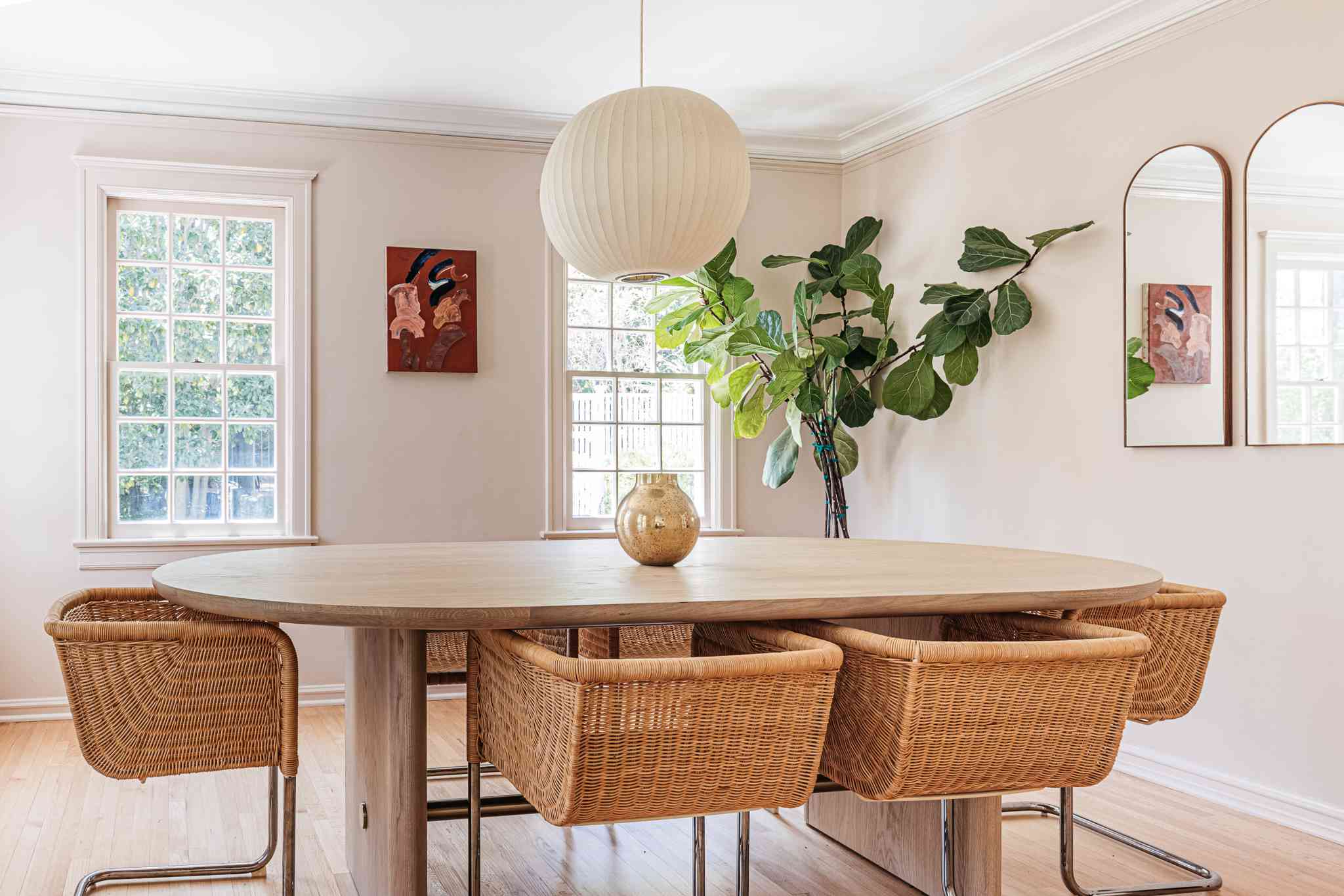 Dining room with a smooth repainted wall finish and crisp baseboards