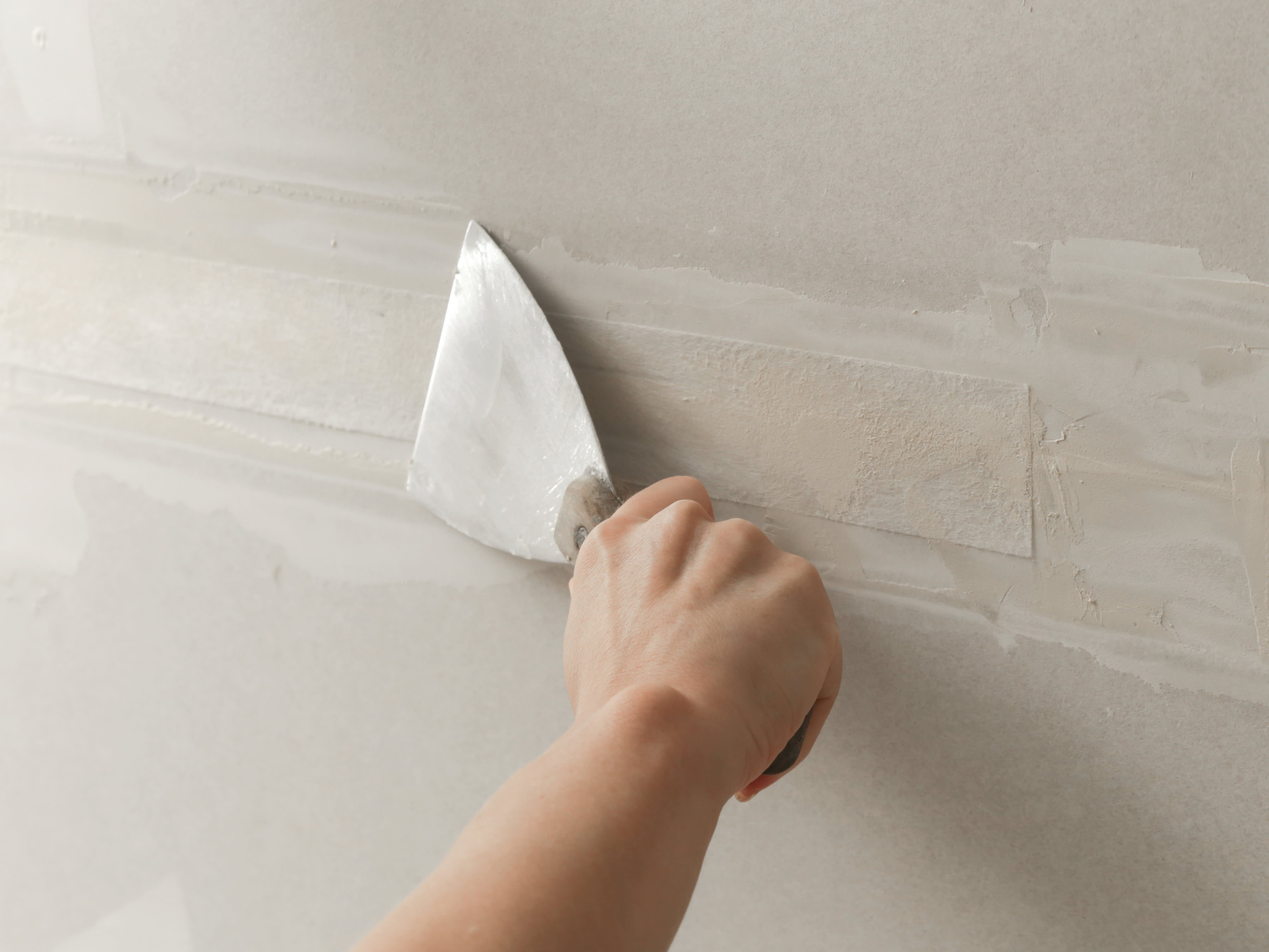 Smooth drywall patch sanded and prepped for paint, illustrating drywall and minor repair work